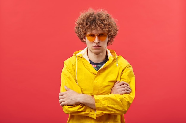 Free Photo fashionable young hipster man with curly ginger hair posing