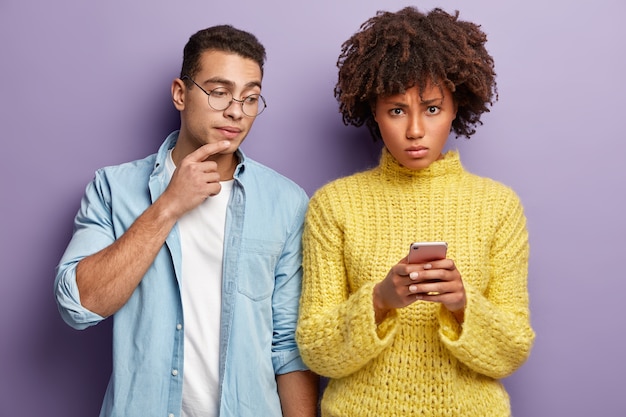 Fashionable young man and woman posing