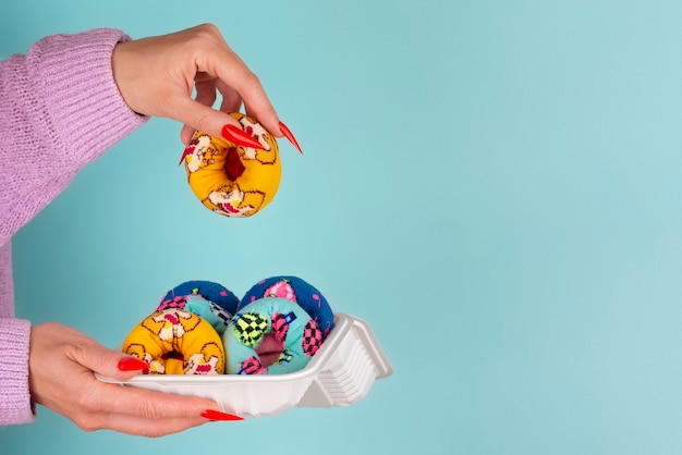 Fast fashion concept with materials and textiles disguised as donuts