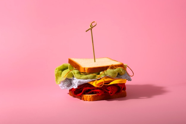 Free photo fast fashion concept with materials and textiles disguised as sandwich