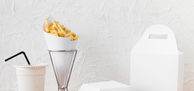 Free photo fast food; disposal cup and food parcel mock up against wall