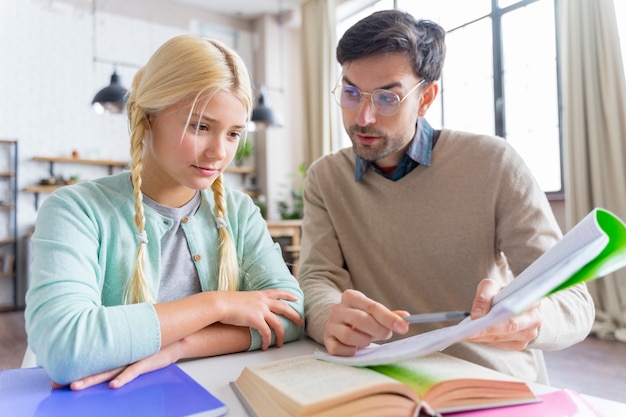 Father being a tutor for her daughter front view