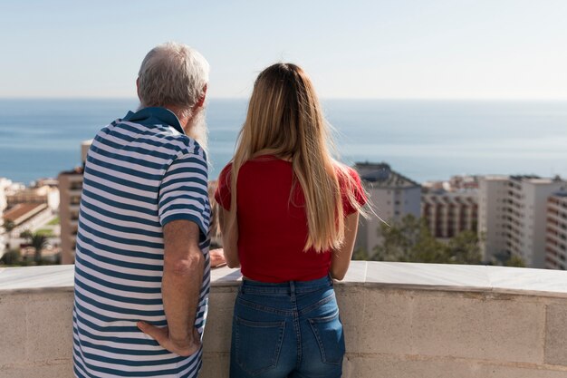 Father and daugher looking at city