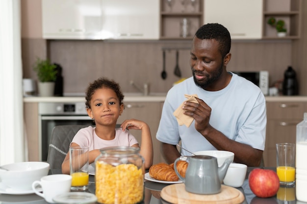 Father and daughter eating together