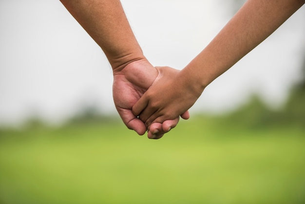 Father and daughter holding hand in hand together