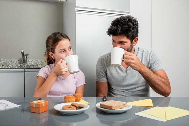 Father and daughter in kitchen on fathers day