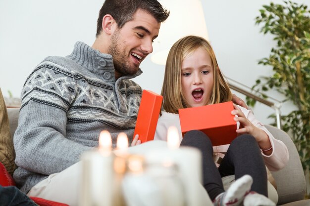 Father and daughter looking at a package