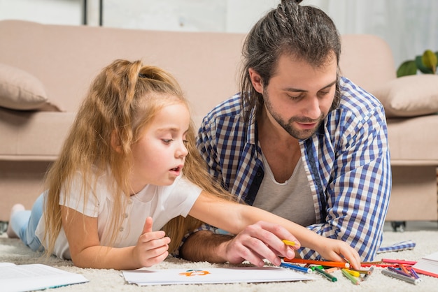 Free photo father and daughter painting on the floor