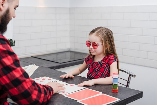 Father and daughter playing cards on fathers day