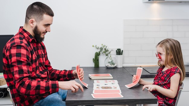 Father and daughter playing cards on fathers day