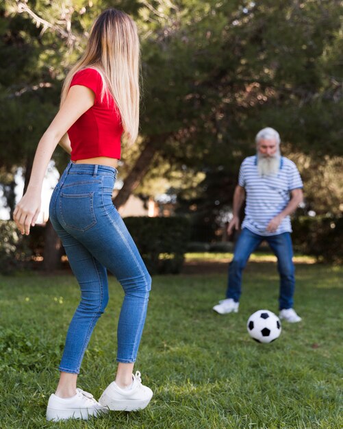 Father and daughter playing soccer