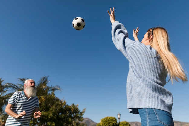 Father and daughter playing with ball