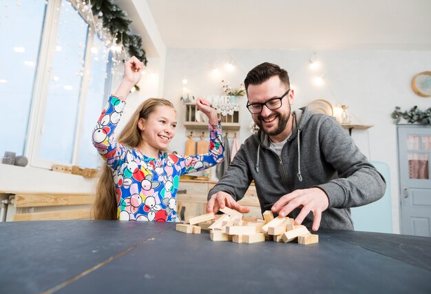 Father and daughter playing with wood blocks