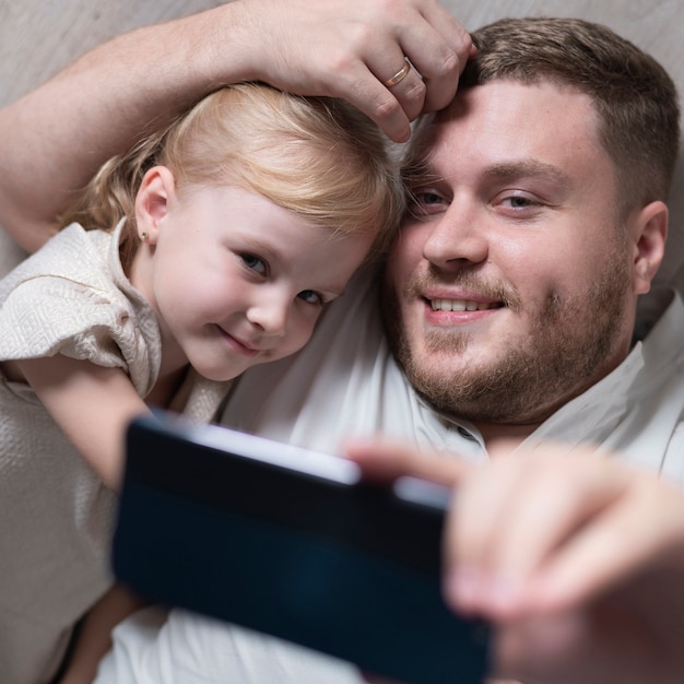 Free photo father and daughter taking selfie at home