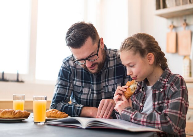 Father and daughter together on breakfast table