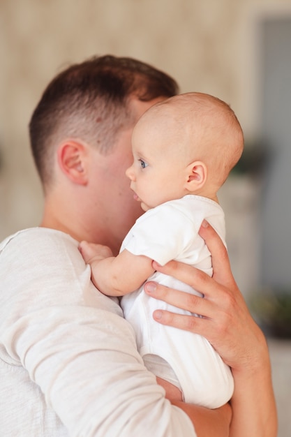 Father holding adorable baby side view