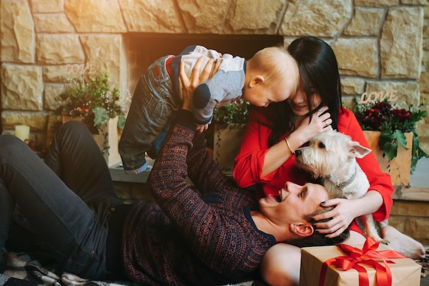 Father holding baby up while his wife looks at them