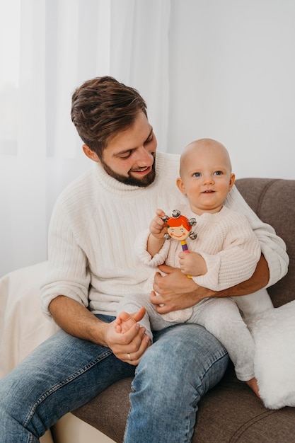 Father at home holding his baby