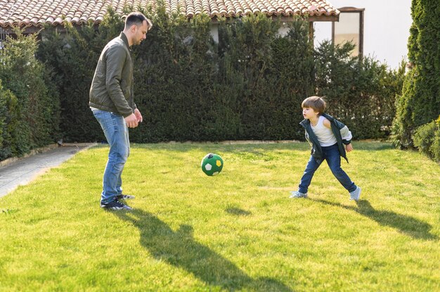 Father and kid playing with ball