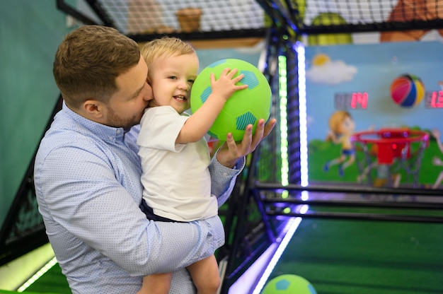 Free Photo father kissing son in playground