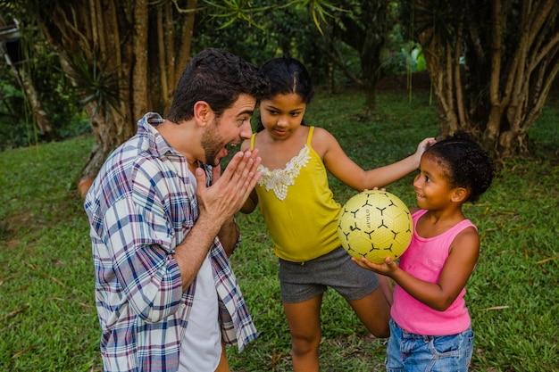 Father playing ball with kids