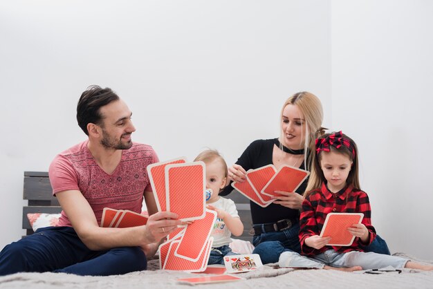 Father playing cards with family