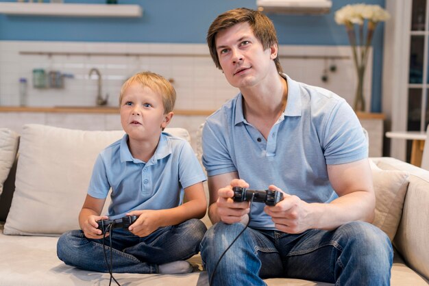 Father playing video games together with son