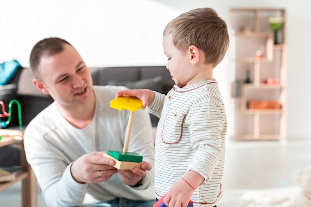 Father playing with baby at home