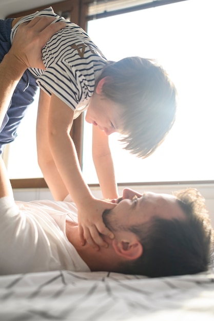 Father playing with smiling son