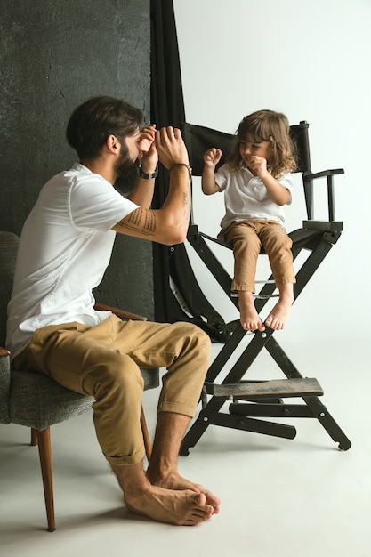 Free Photo father playing with young son in their sitting room at home. young dad having fun with his children in holidays or weekend