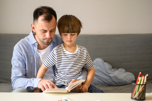 Father reading book to son