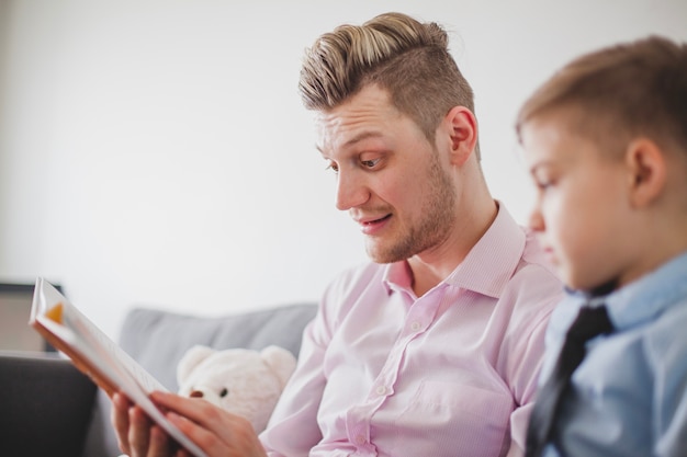 Free photo father reading a story to his son