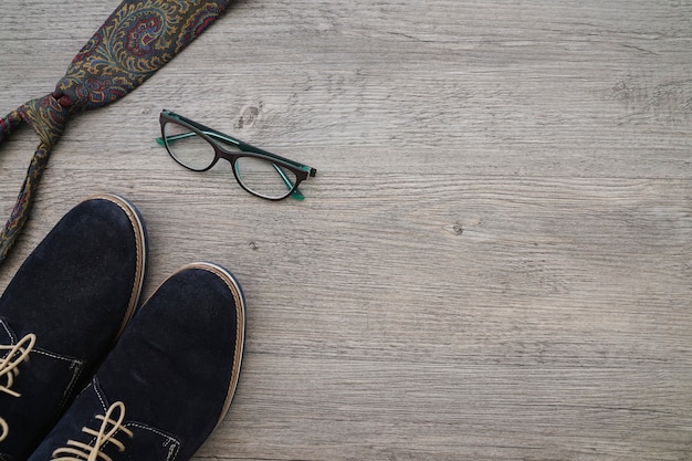 Father's day composition with shoes, necktie and glasses