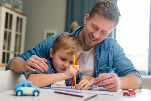 Father's day dad and son colouring a book