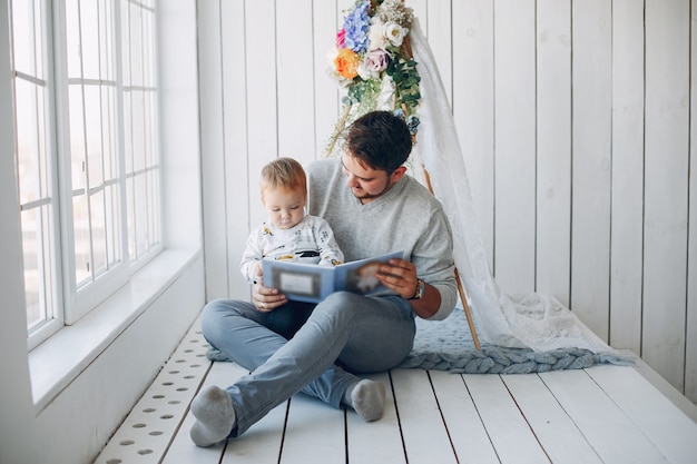 Free photo father sitting at home with little son