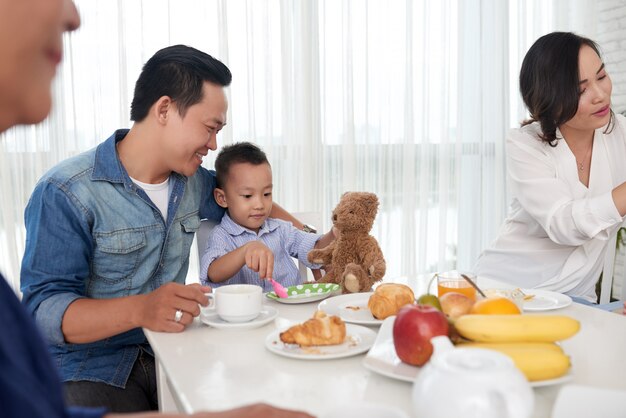 Father and Son at Breakfast with Family