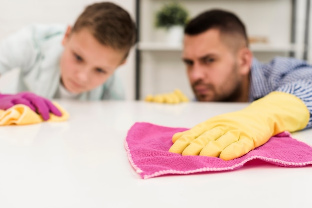 Free Photo father and son cleaning thoroughly