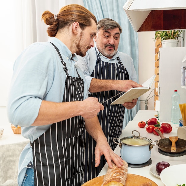 Father and son cooking after a recipe