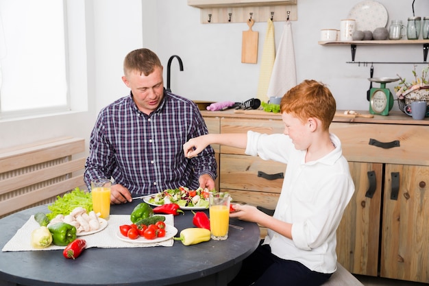 Father and son cooking together