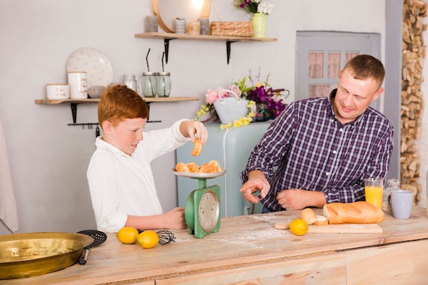 Father and son cooking together