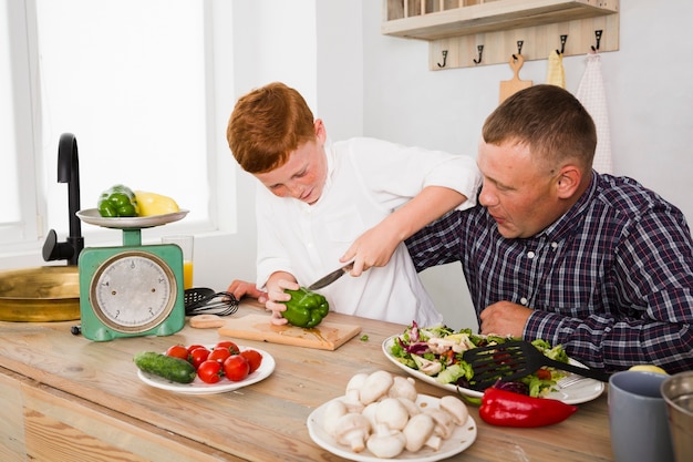 Father and son cooking together