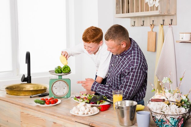 Father and son cooking together