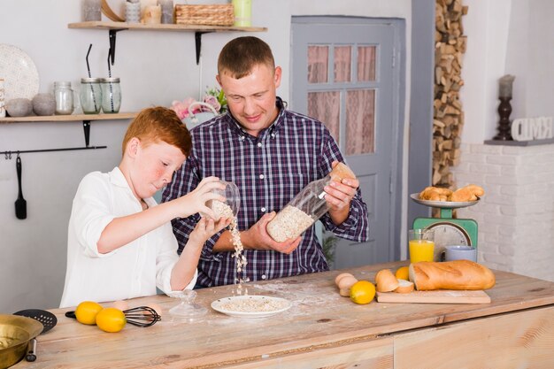 Father and son cooking together