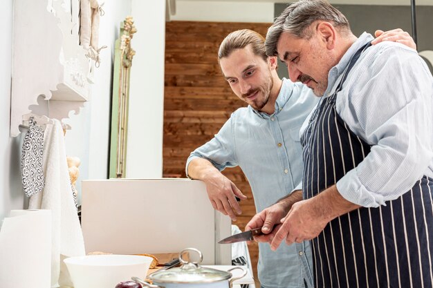 Father and son cooking together