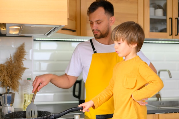 Father and son cooking together