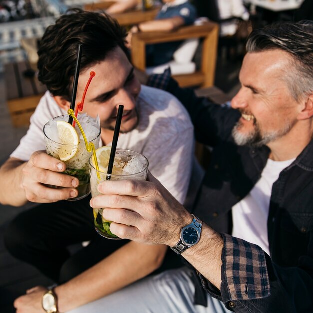 Father and son drinking cocktail