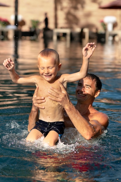 Father and son enjoying a day at the swimming pool together