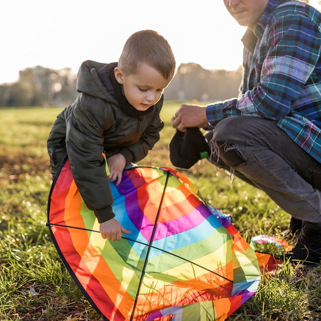 Father and son fixing a kite