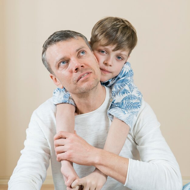 Father and son hugging him