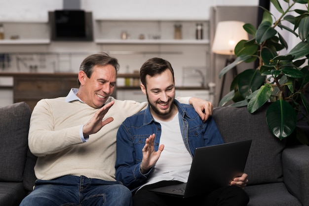 Father and son looking at laptop